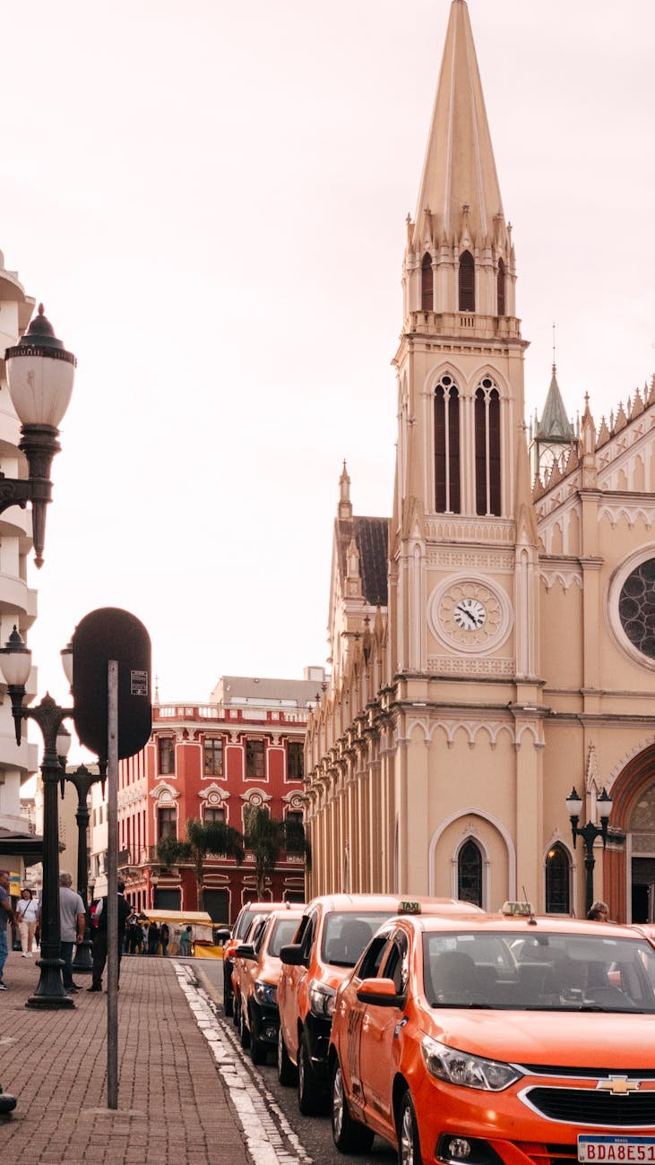 Gothic cathedral and vibrant street in Curitiba, showcasing urban life and architecture.
